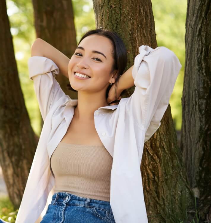 portrait-of-beautiful-asian-woman-resting-near-tre-2023-11-27-04-51-43-utc